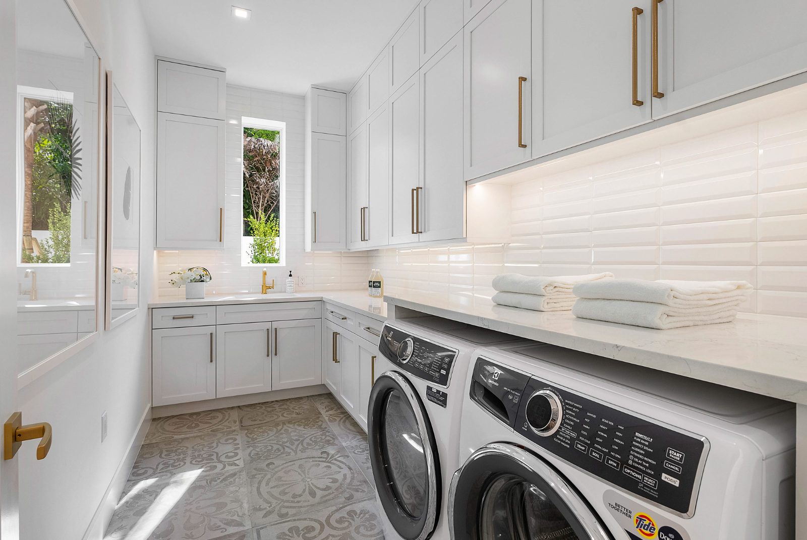 Laundry room with custom cabinetry, folding counter and tile floor, Delray Beach FL