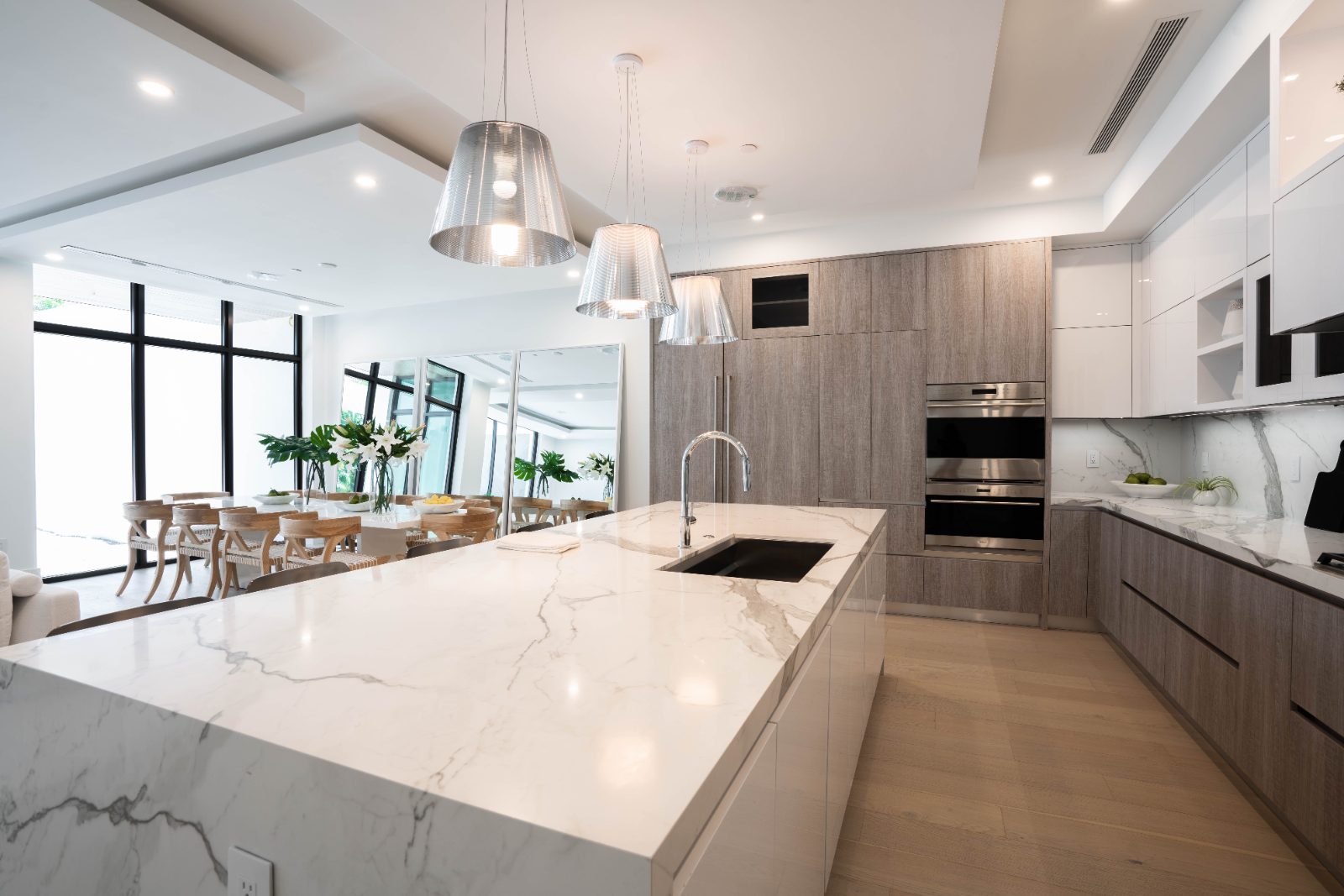 Custom kitchen with marble island and black-framed glass cabinets, Delray Beach FL