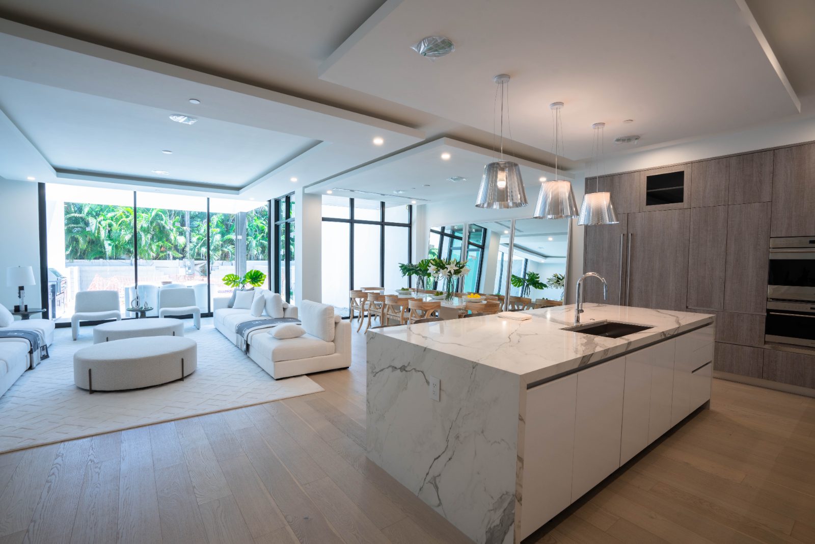 Open-concept custom kitchen with waterfall marble island, Fort Lauderdale FL