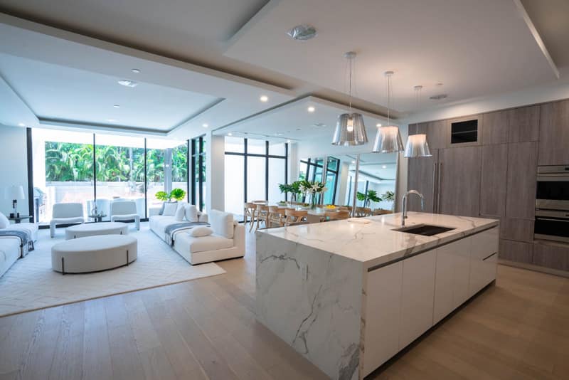 Open-concept custom kitchen with waterfall marble island, Fort Lauderdale FL